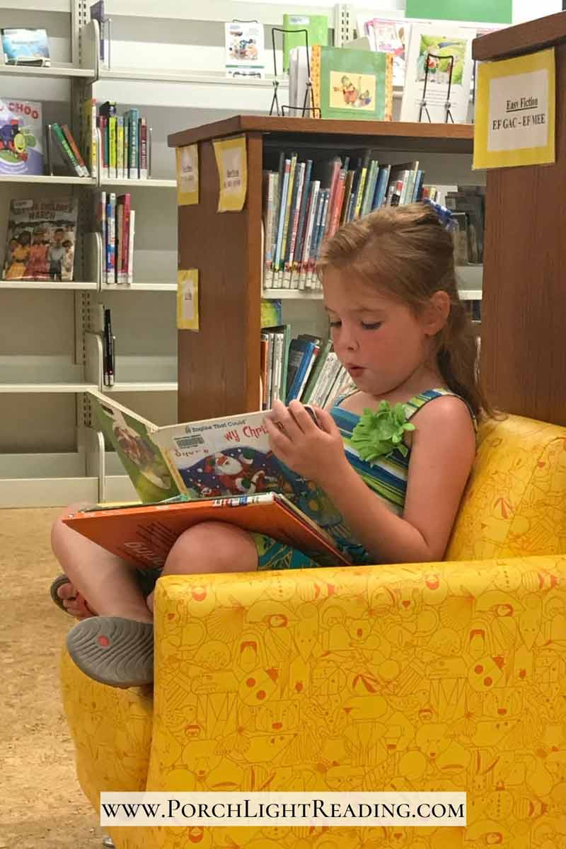 Toddler reading at the library. 