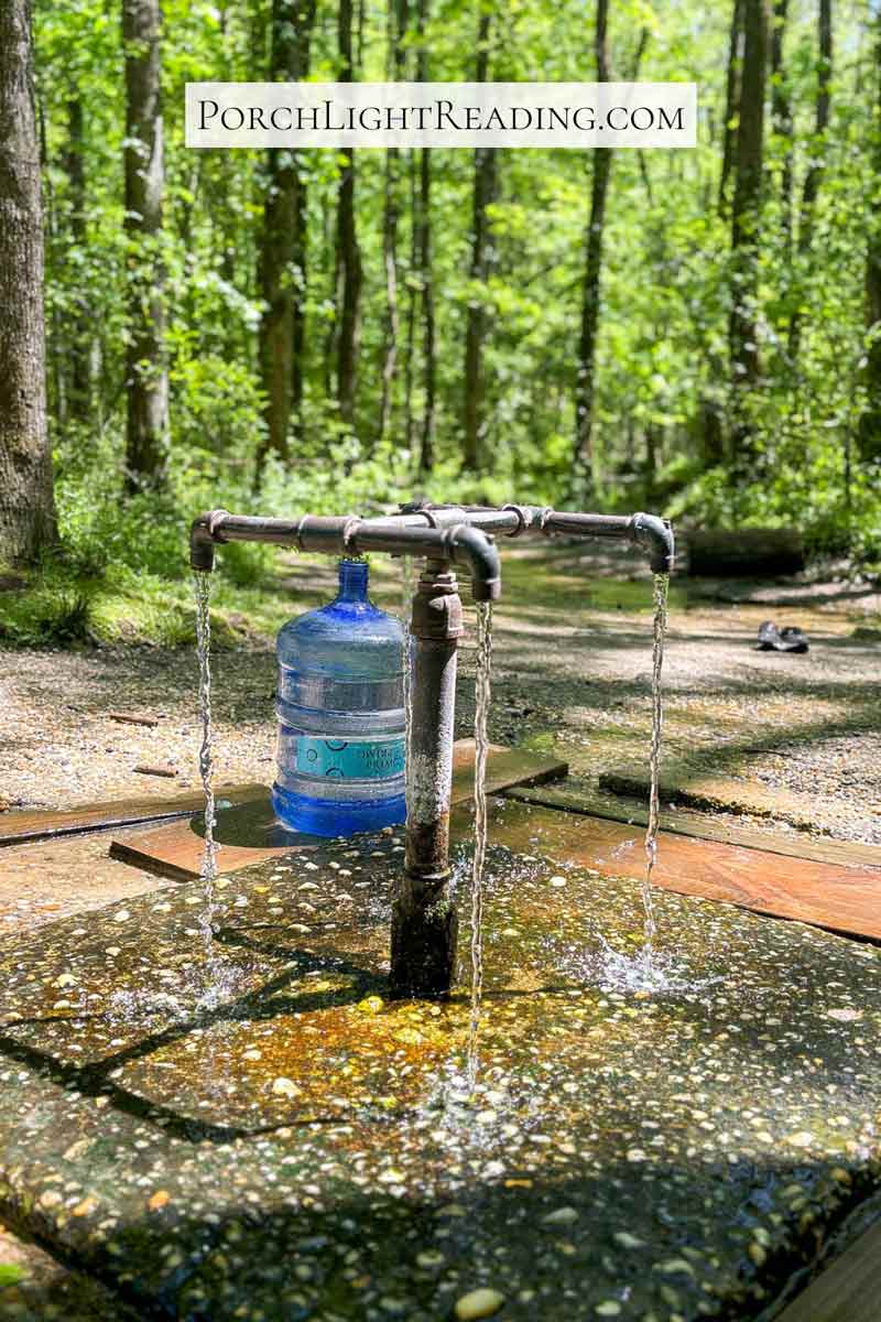 Spring water coming from 4 pipes next to a beautiful creek. 
