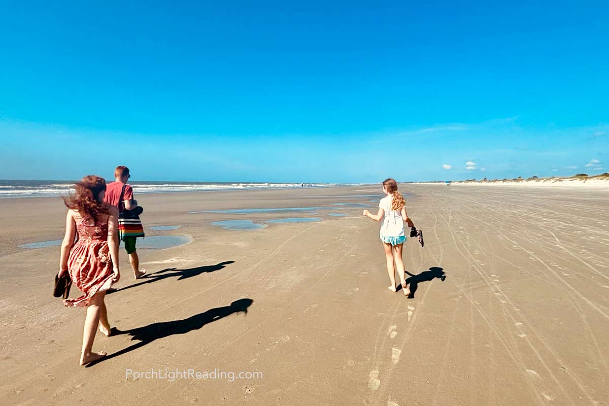 Family strolling along the ocean beach at Kiawah Beachwalker Park. 