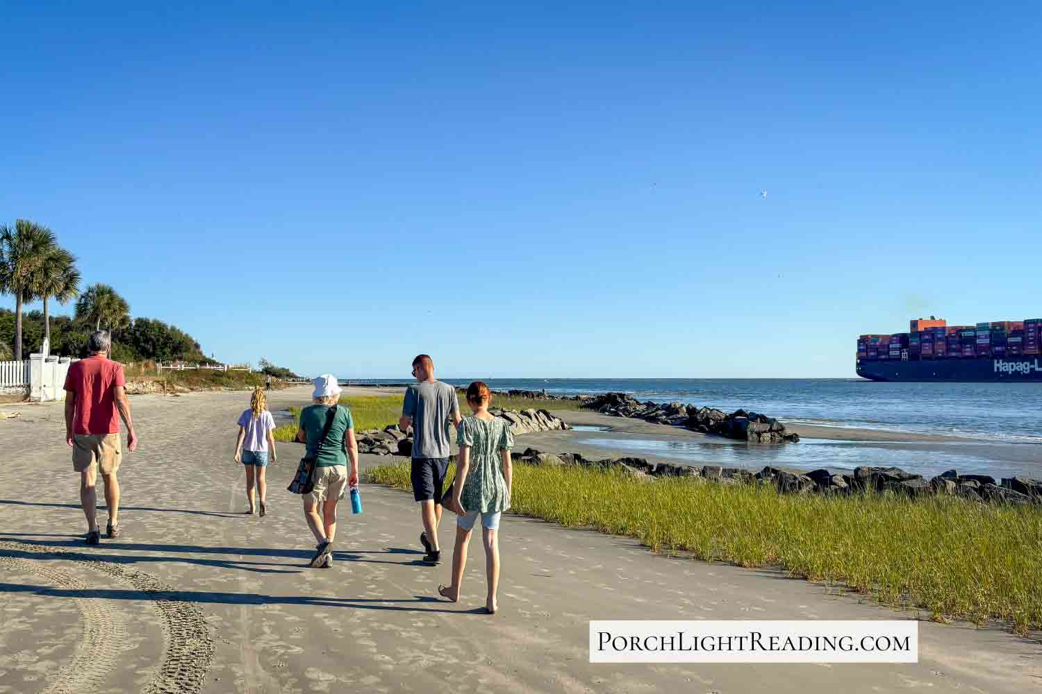 Family walking along Sullivan's Island beach. 