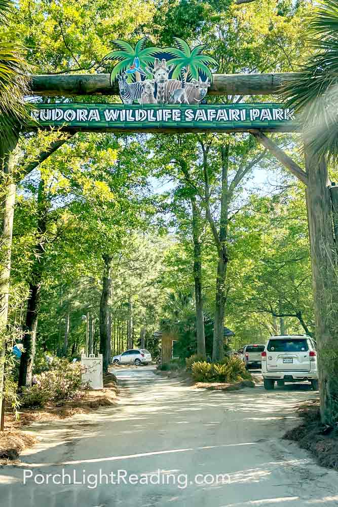 Driving under a large wooden sign with the park name. 