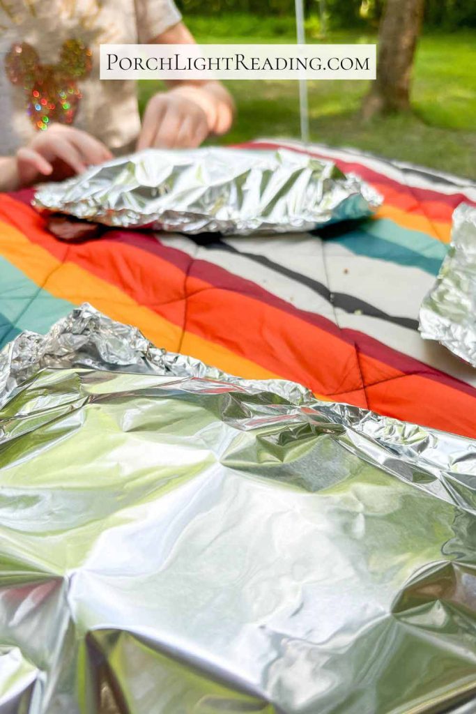 Closing the tin foil packet by rolling the edges. 
