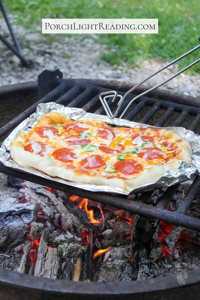 Moving the pizza by using tongs. 