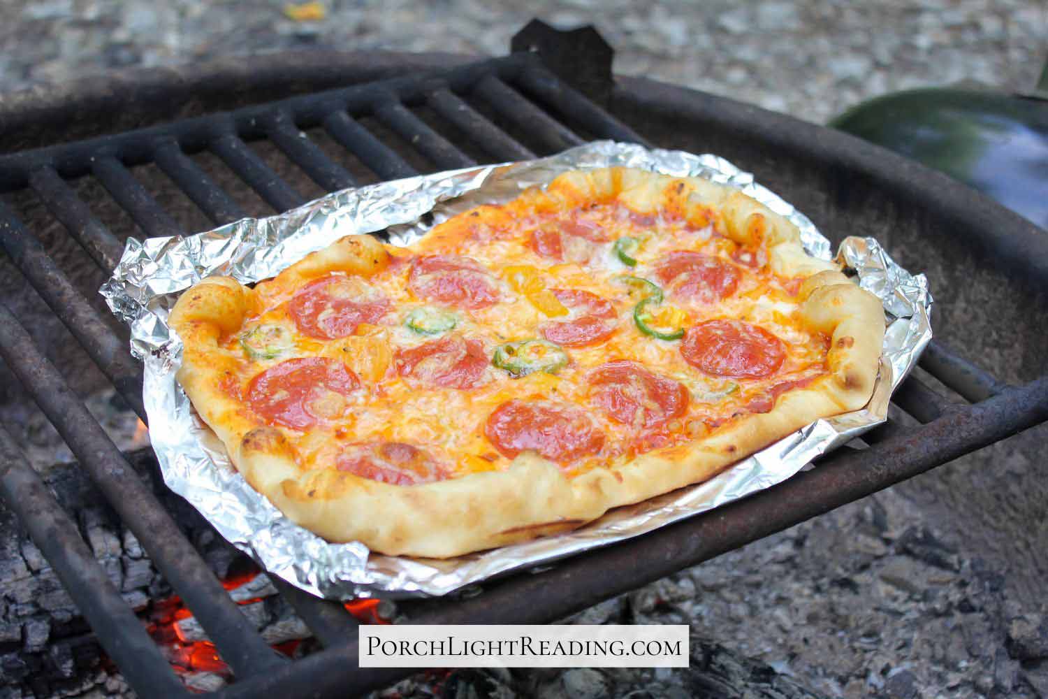 Campfire pizza recipe made over hot coals. With pepperoni and peppers. 