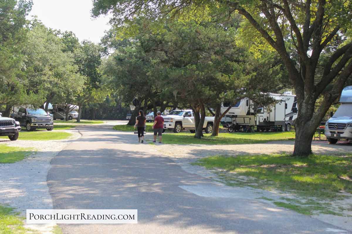 Two people walking the campground road. 