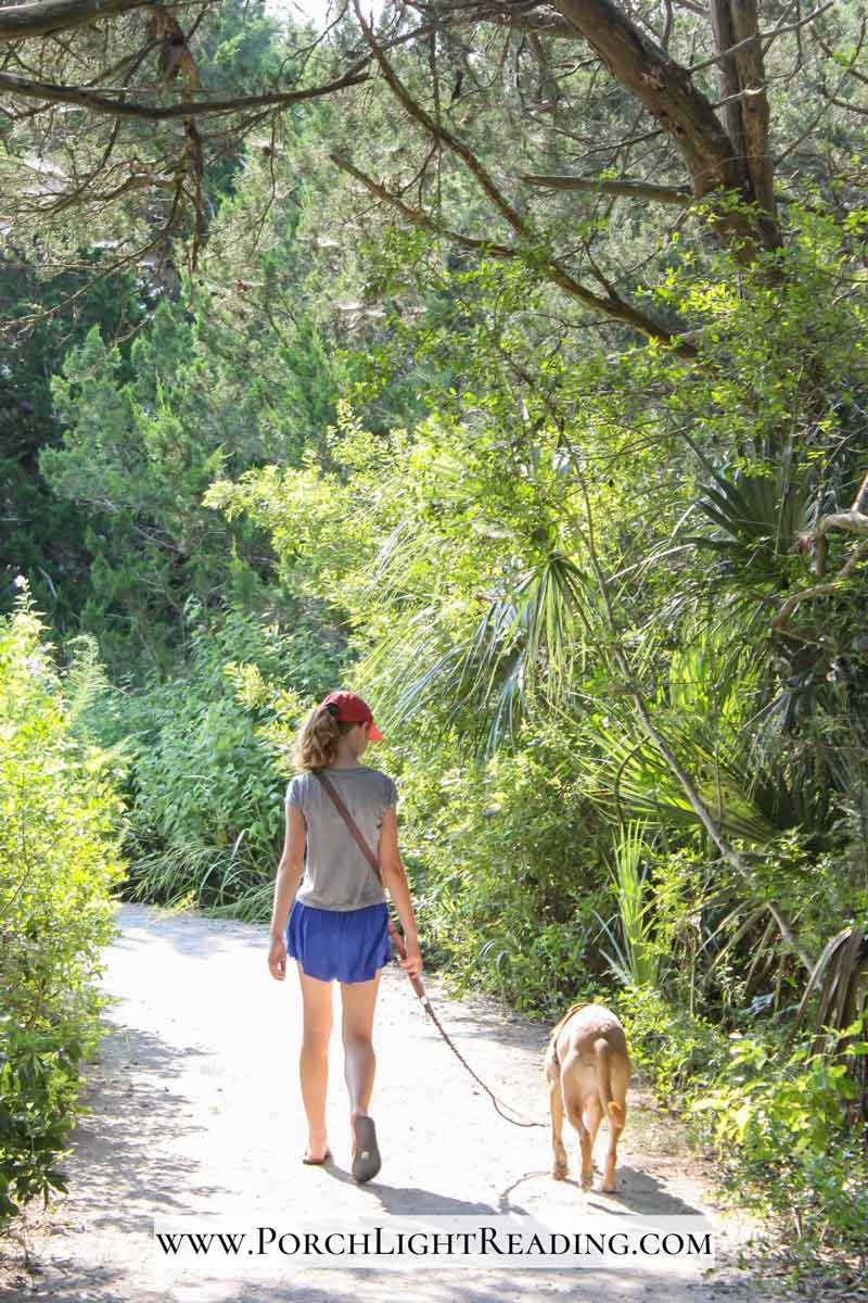 Young girl walking her dog along the trails. 