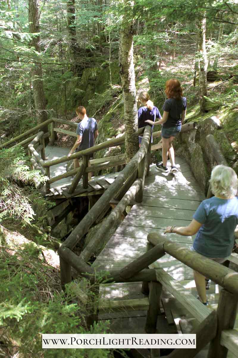 Family walking down the stairs and boardwalk into the gorge.
