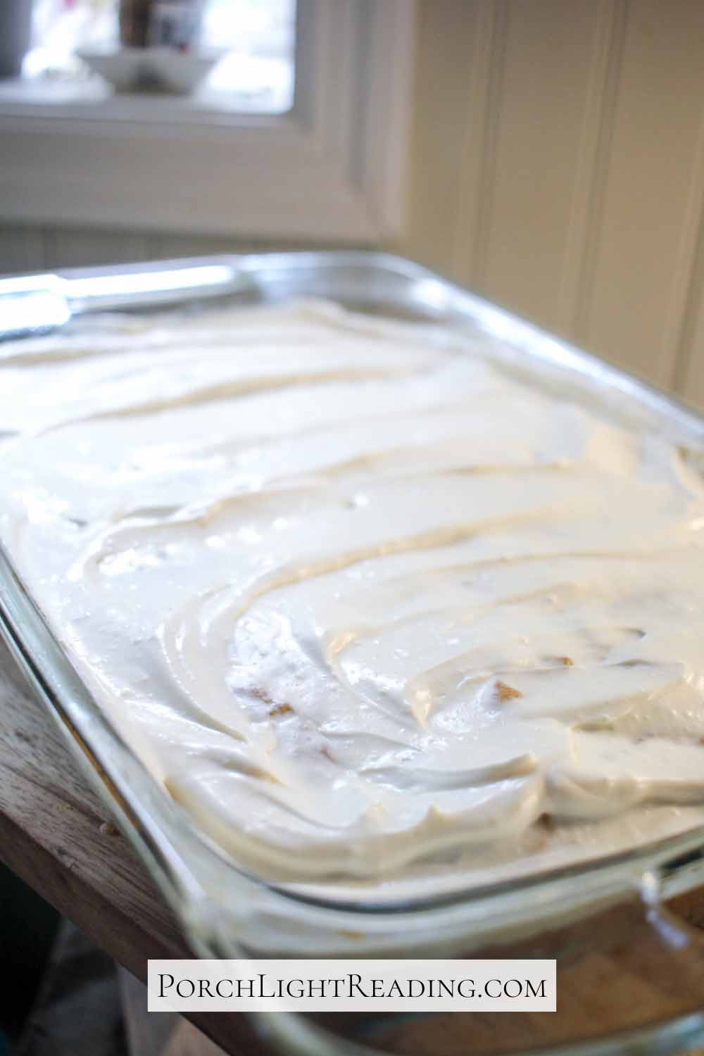 Frosting the banana snack cake smooth.
