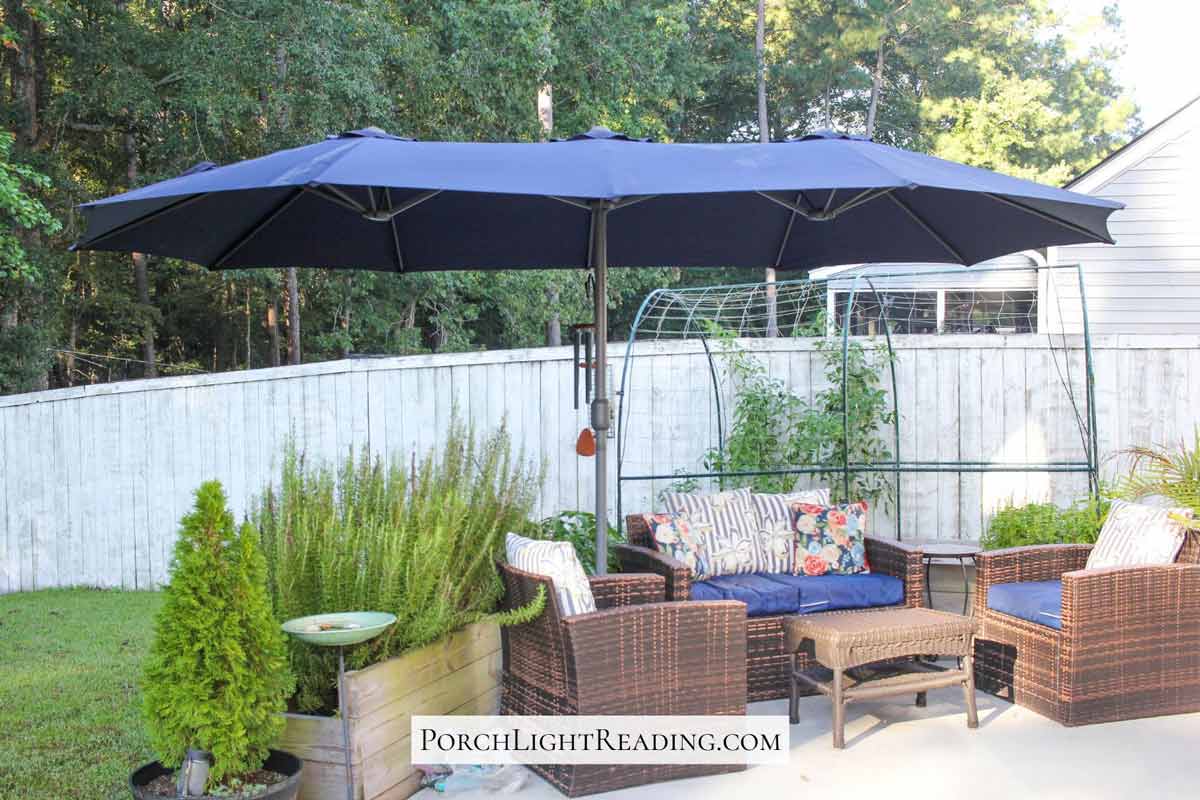 Open 15 foot umbrella canopy replacement with matching blue patio cushions.